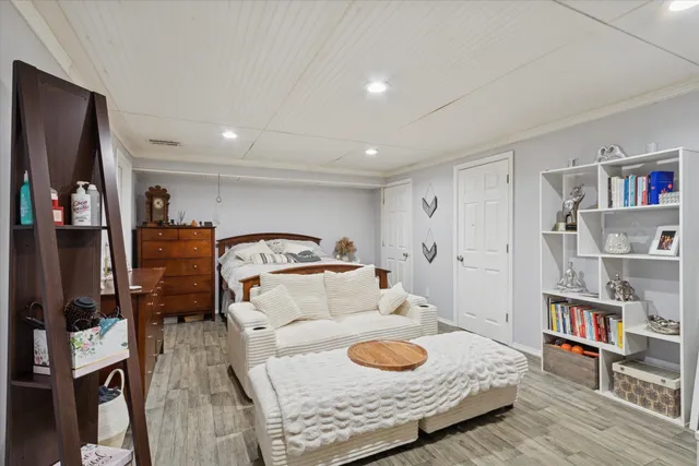 a bedroom with furniture and a book shelf