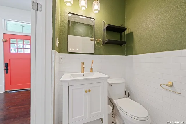 a bathroom with a toilet sink and mirror