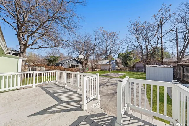 a view of a house with a wooden fence