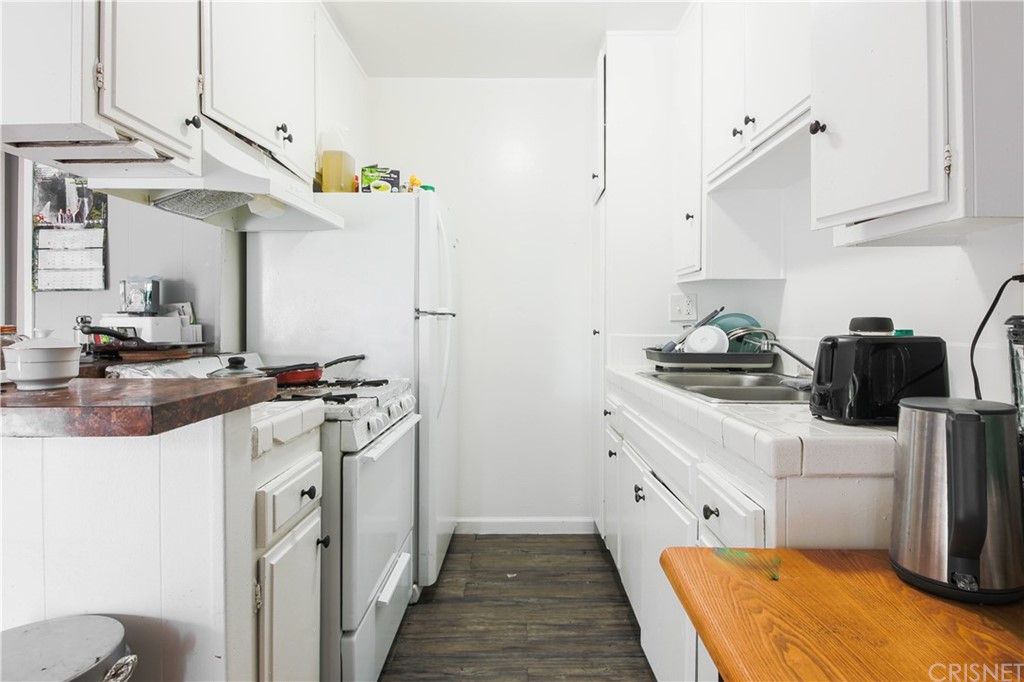 14224 Erwin Street Van Nuys, CA 91401 - Photo 14 of 18 a kitchen with stainless steel appliances granite countertop a sink stove and refrigerator