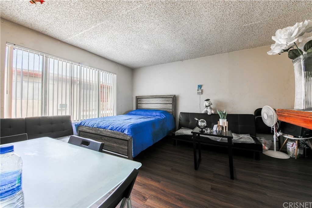 14224 Erwin Street Van Nuys, CA 91401 - Photo 16 of 18 a bedroom with furniture and wooden floor