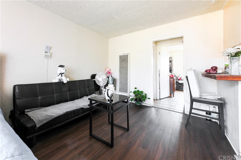 14224 Erwin Street Van Nuys, CA 91401 - Photo 17 of 18 a living room with furniture and wooden floor
