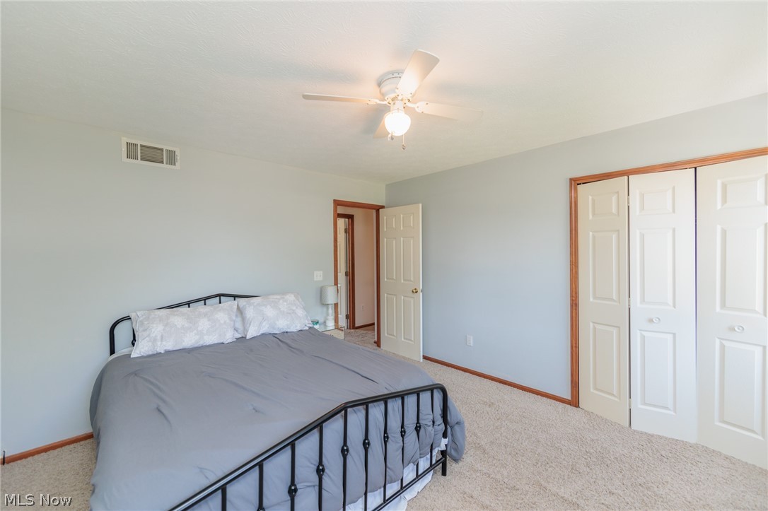 5630 Oak Point Road Lorain, OH 44053 - Photo 24 of 44 Carpeted bedroom with a closet and ceiling fan