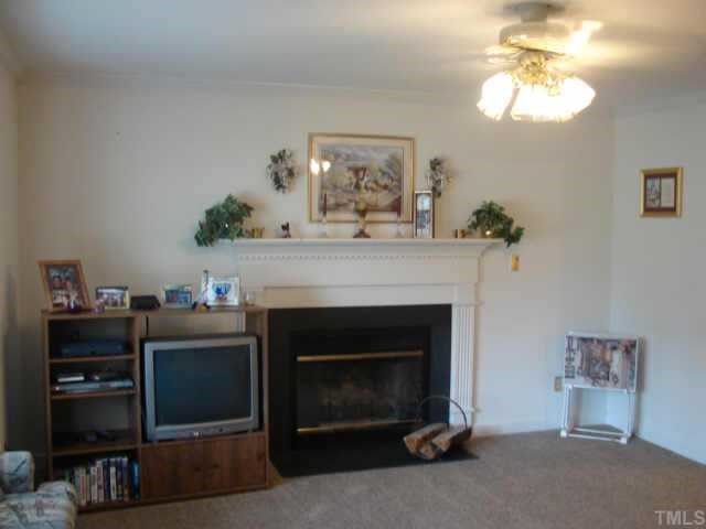4229 Birmingham Way Raleigh, NC 27604 - Photo 3 of 7 a living room with furniture and a fireplace