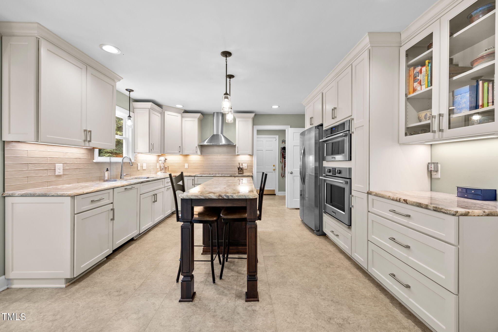 11941 Straight A Way Lane Raleigh, NC 27613 - Photo 8 of 62 a kitchen with stainless steel appliances kitchen island granite countertop a table chairs sink and cabinets