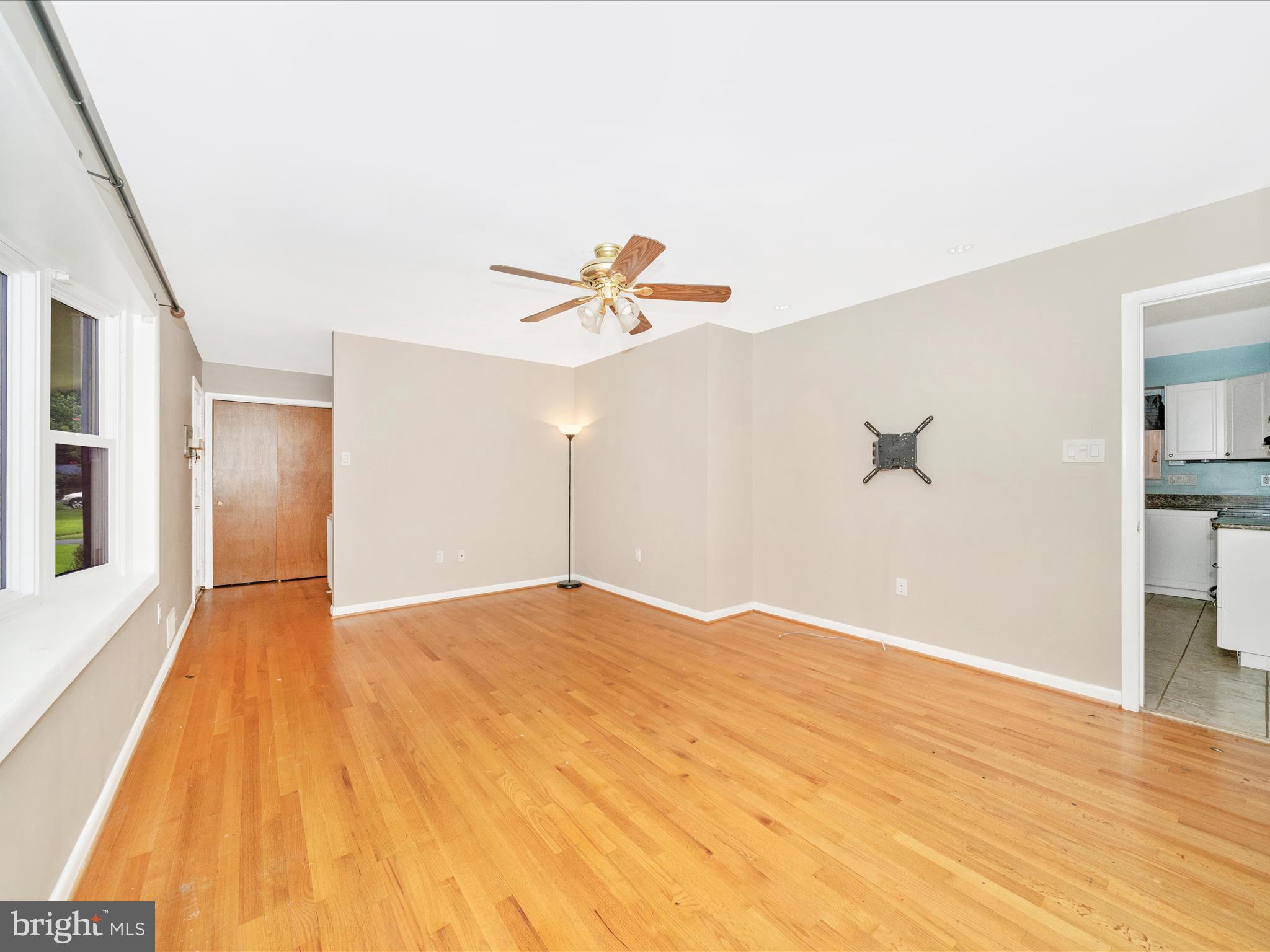 7019 Fitzpatrick Drive Laurel, MD 20707 - Photo 11 of 59 a view of empty room with wooden floor and fan