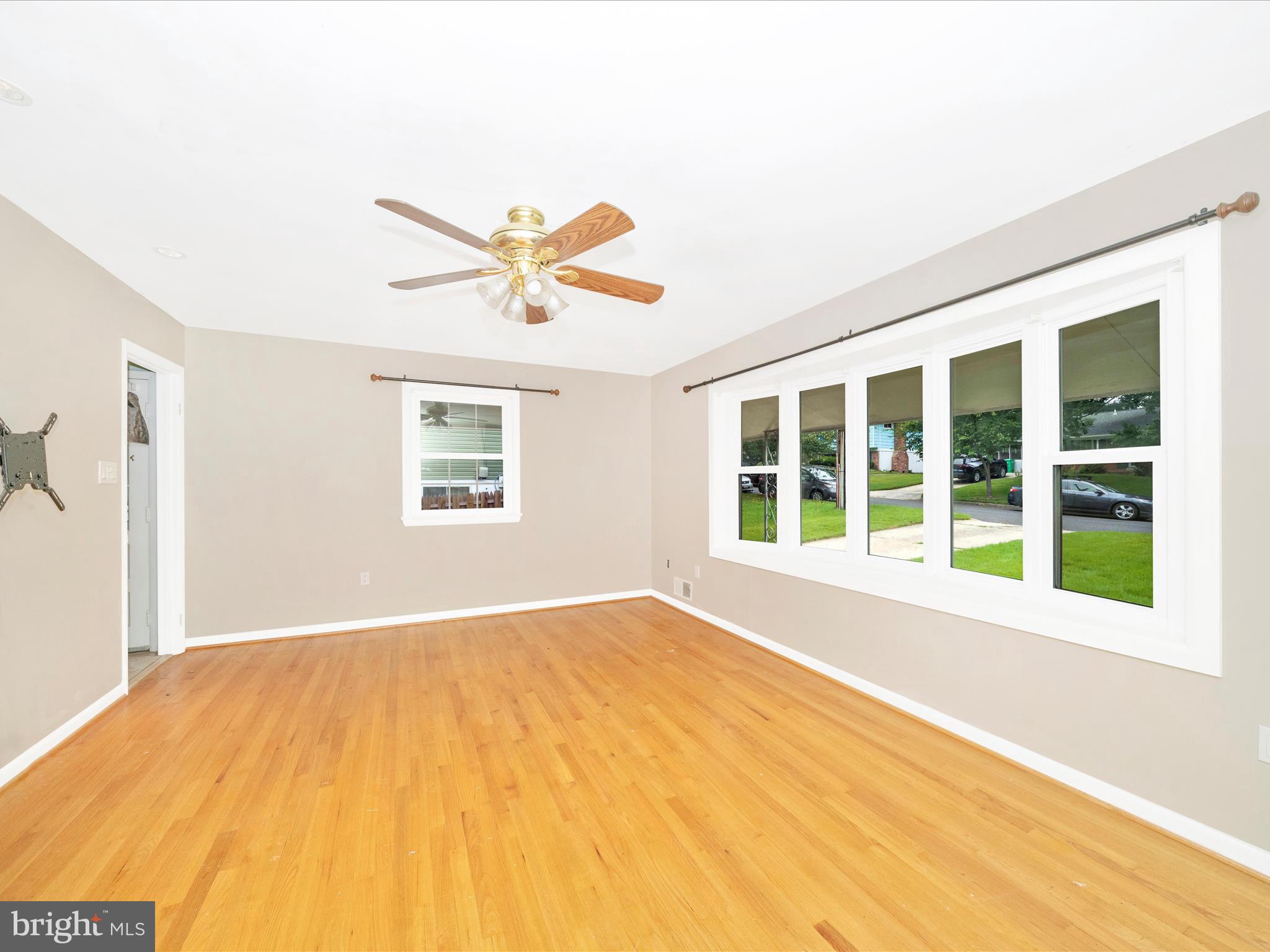 7019 Fitzpatrick Drive Laurel, MD 20707 - Photo 12 of 59 a view of an empty room with a window and a ceiling fan