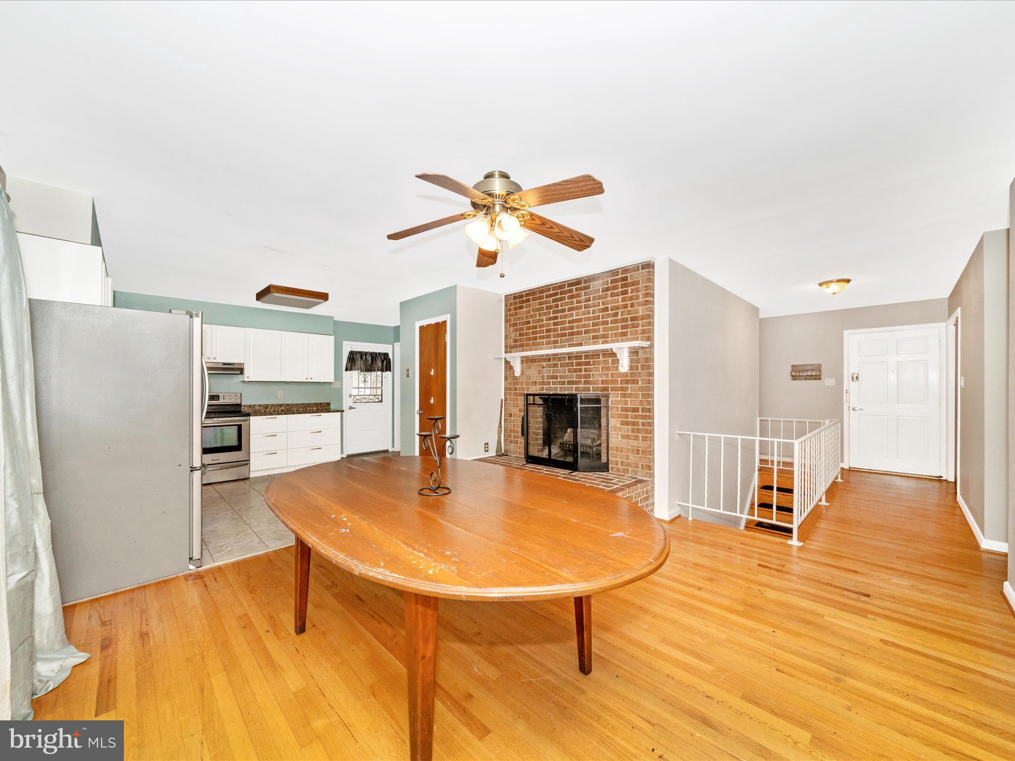 7019 Fitzpatrick Drive Laurel, MD 20707 - Photo 20 of 59 a living room with stainless steel appliances furniture a fireplace and a kitchen view