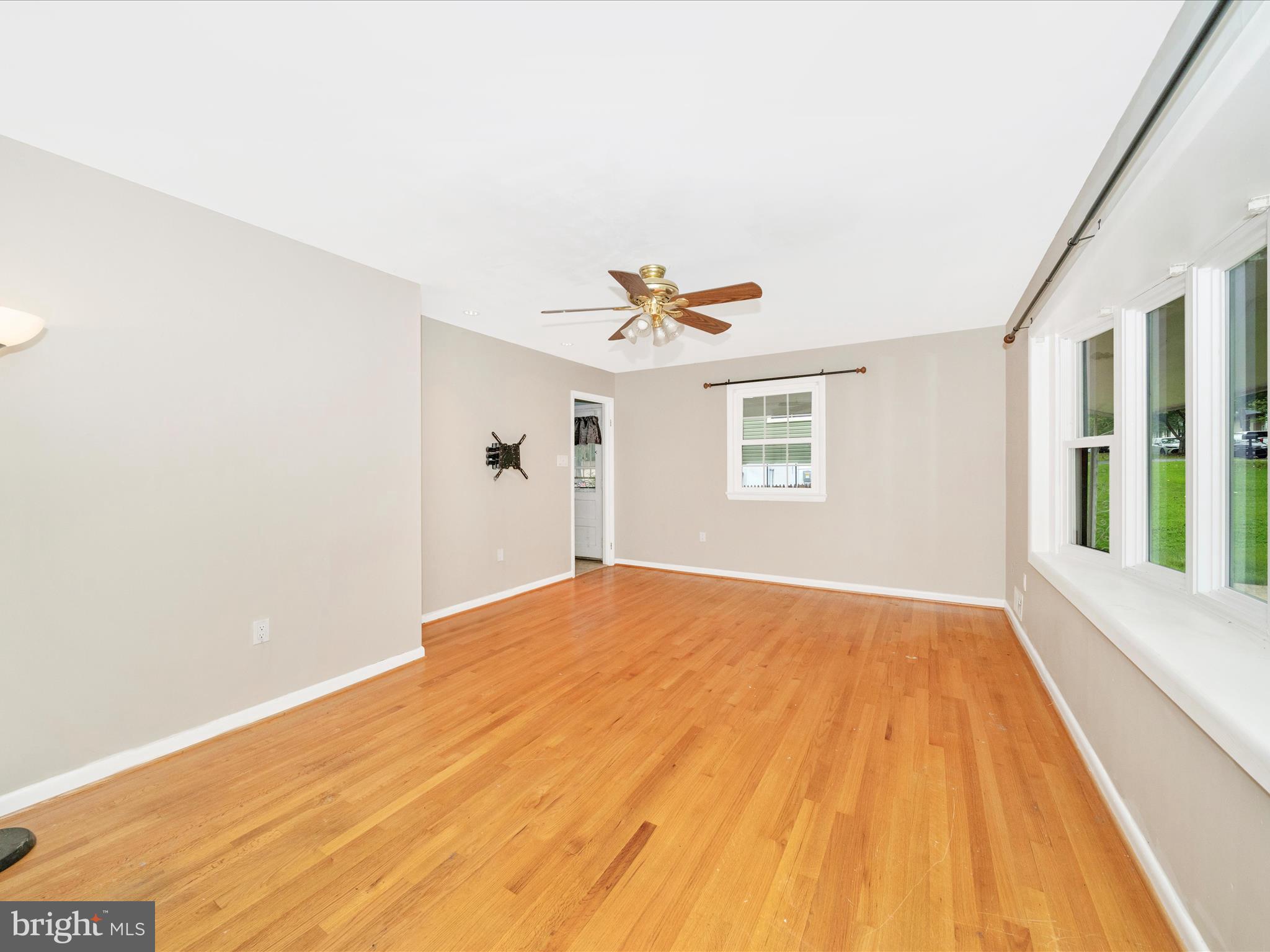 7019 Fitzpatrick Drive Laurel, MD 20707 - Photo 8 of 59 a view of a big room with windows and ceiling fan