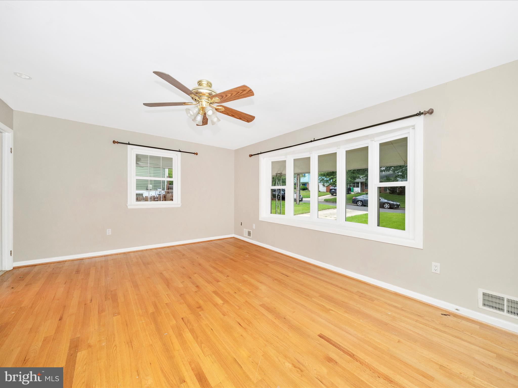 7019 Fitzpatrick Drive Laurel, MD 20707 - Photo 9 of 59 a view of an empty room with a window and a ceiling fan