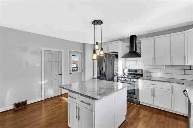 a kitchen with granite countertop a stove and a sink