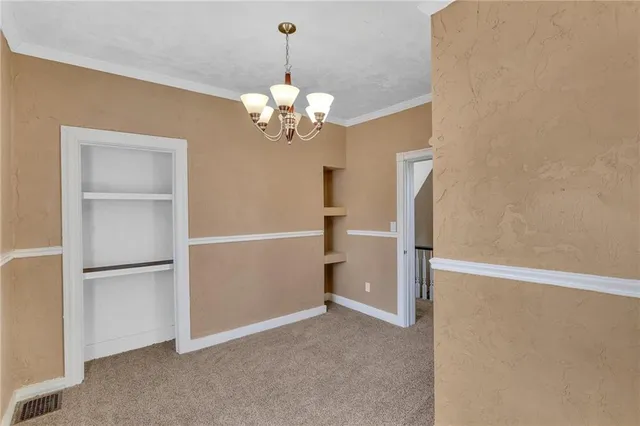 a view of a chandelier fan and refrigerator in a room
