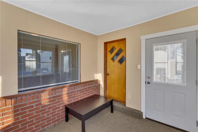a view of a hallway with wooden floor and entryway