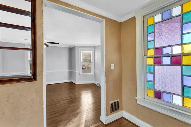 a view of an entryway with wooden floor and a window