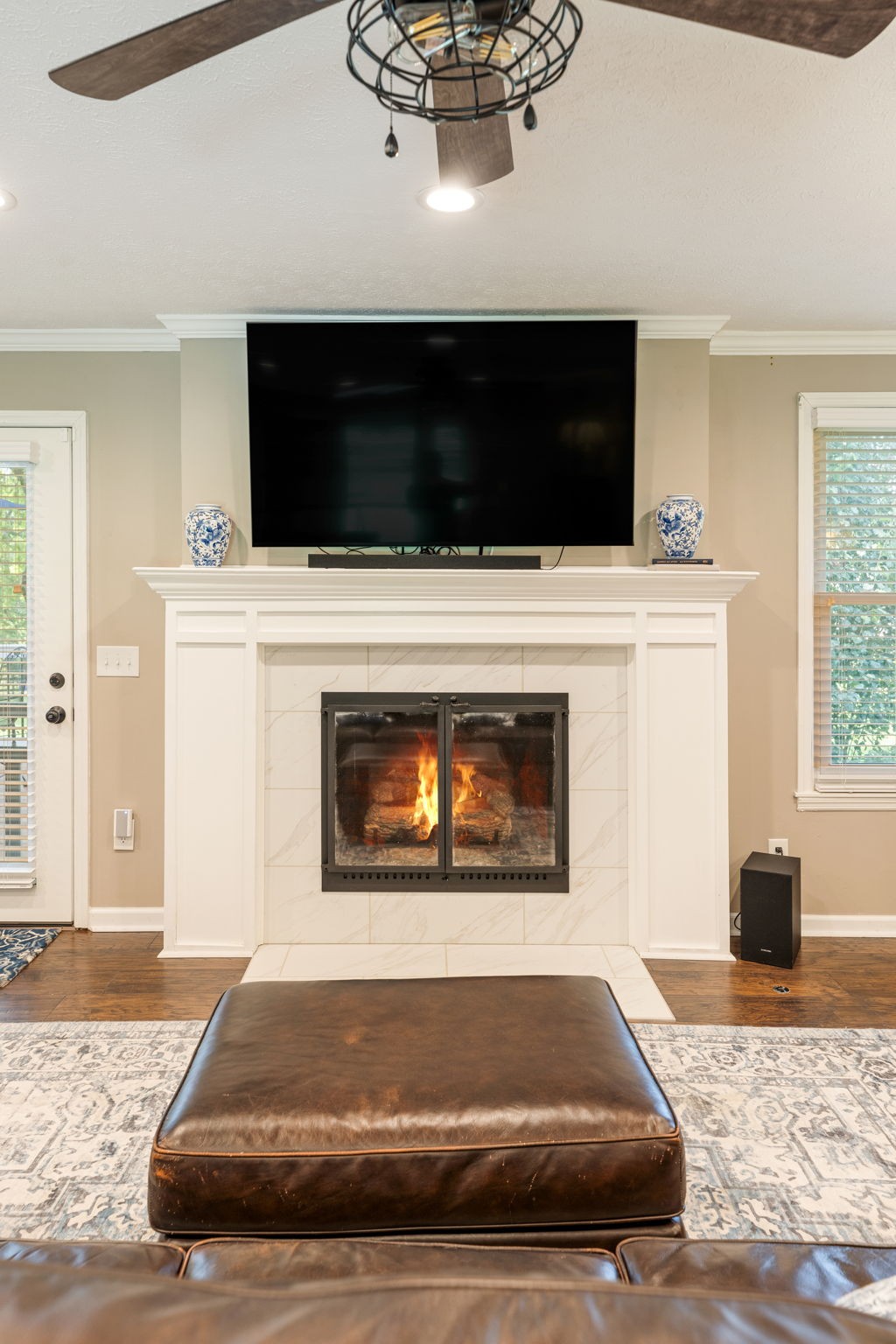 7367 Crow Cut Road Fairview, TN 37062 - Photo 19 of 96 a living room with a fireplace and a flat screen tv