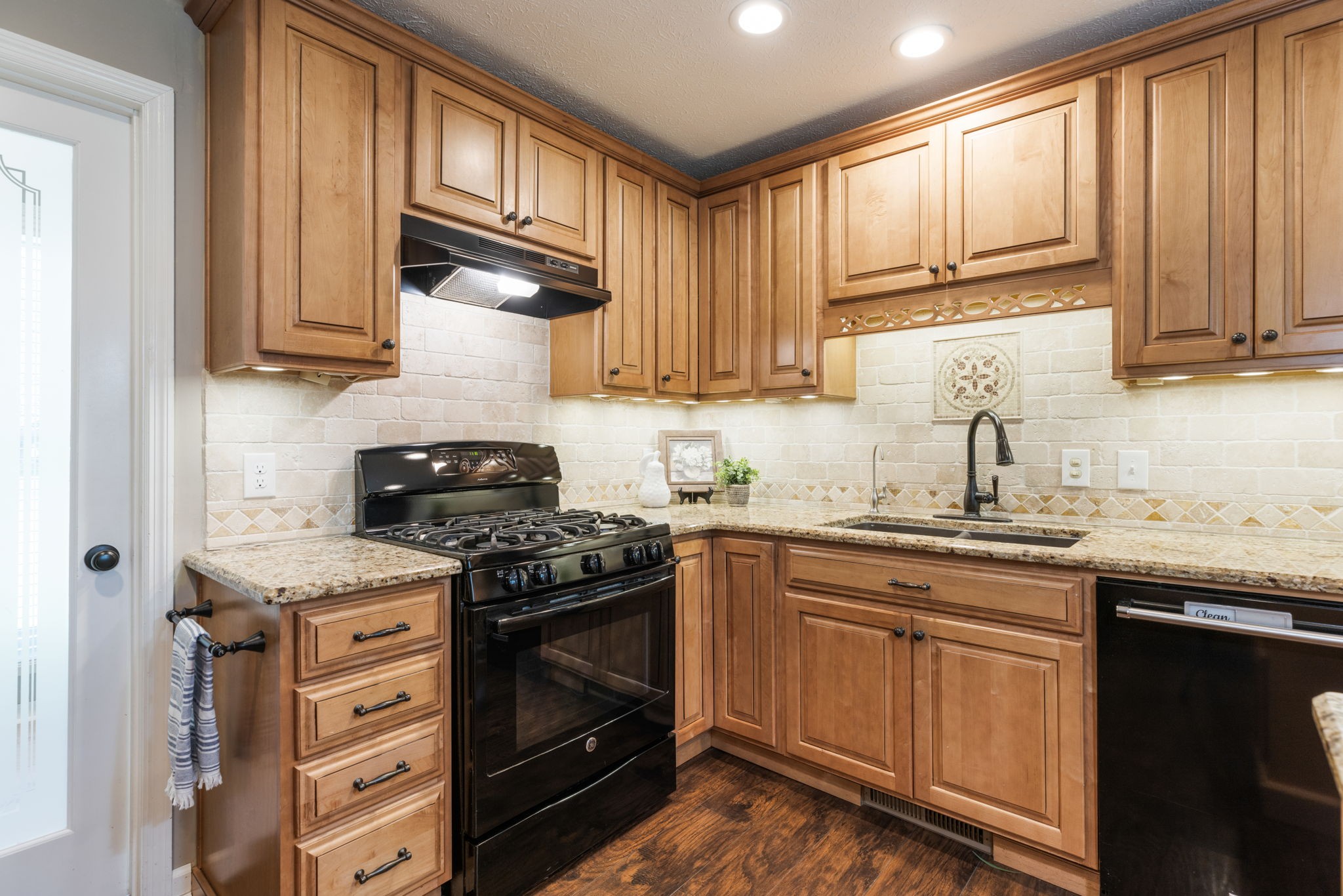 7367 Crow Cut Road Fairview, TN 37062 - Photo 31 of 96 a kitchen with stainless steel appliances granite countertop a sink stove and cabinets