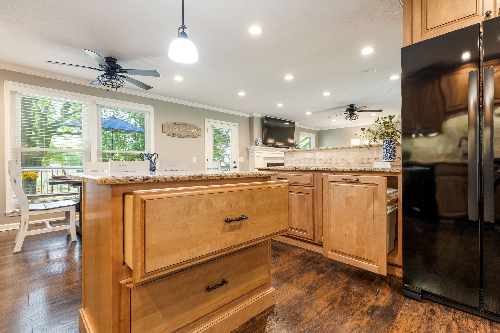 7367 Crow Cut Road Fairview, TN 37062 - Photo 38 of 96 a kitchen with stainless steel appliances granite countertop a refrigerator a sink dishwasher a stove and white cabinets with wooden floor