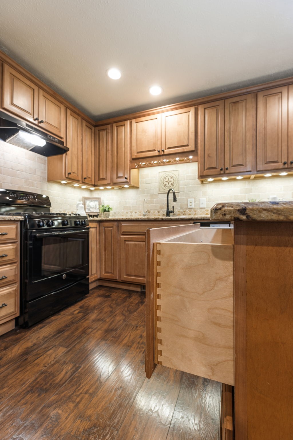 7367 Crow Cut Road Fairview, TN 37062 - Photo 40 of 96 a kitchen with stainless steel appliances granite countertop a stove a sink and a microwave