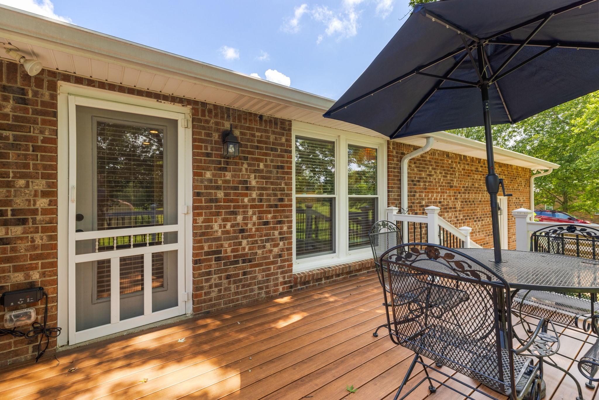 7367 Crow Cut Road Fairview, TN 37062 - Photo 59 of 96 a view of a patio with a table and chairs under an umbrella