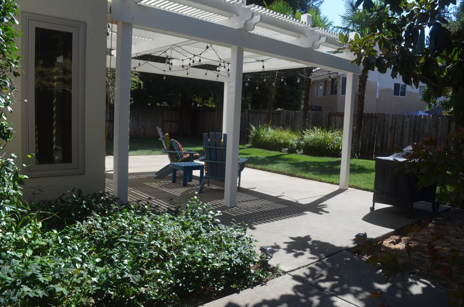 8392 Red Fox Way Elk Grove, CA 95758 - Photo 19 of 30 a view of a patio with table and chairs potted plants and floor to ceiling window