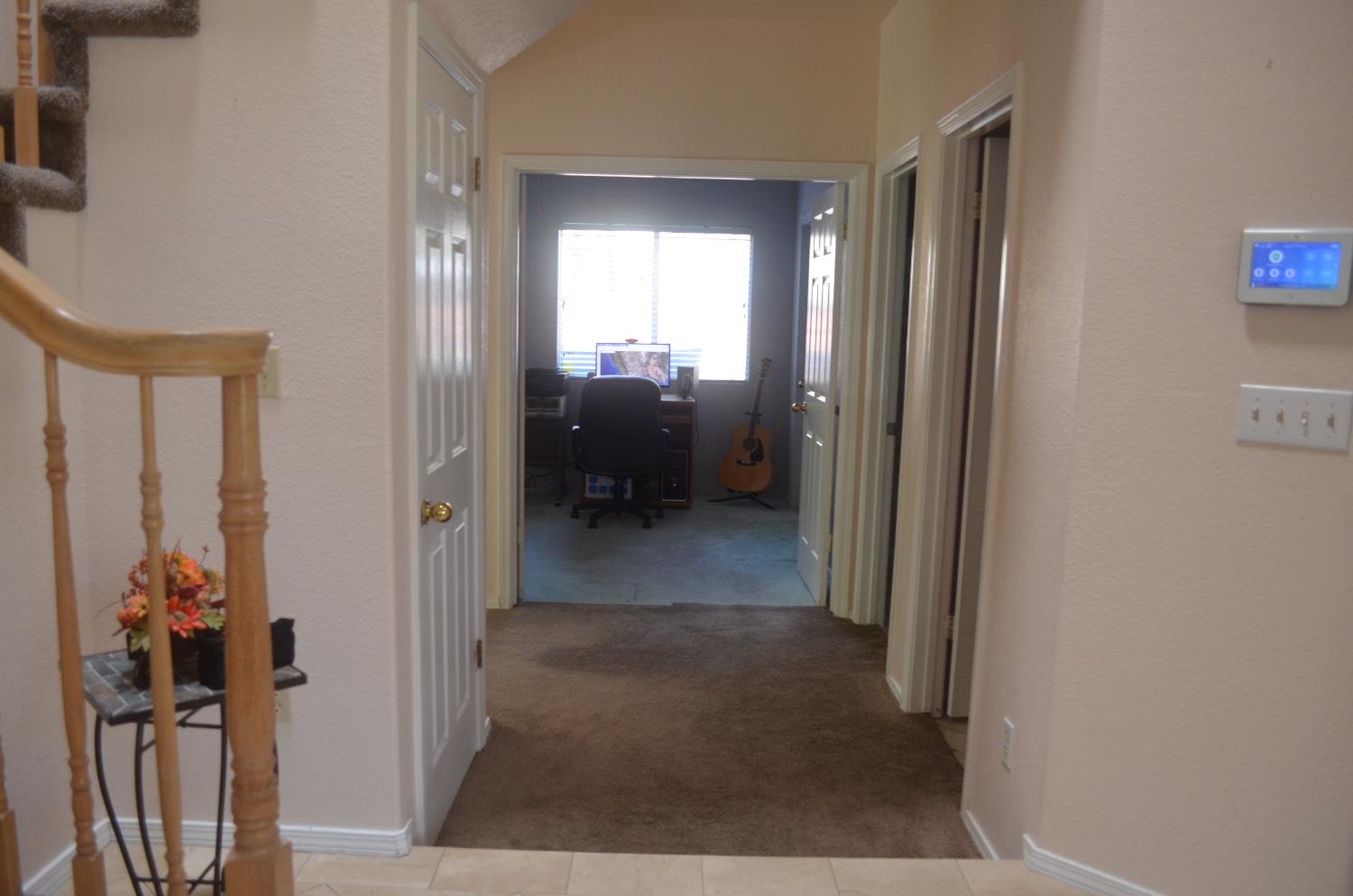 8392 Red Fox Way Elk Grove, CA 95758 - Photo 8 of 30 a view of a hallway with wooden shelves