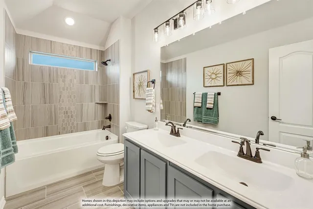 a bathroom with a double vanity sink toilet mirror and bathtub