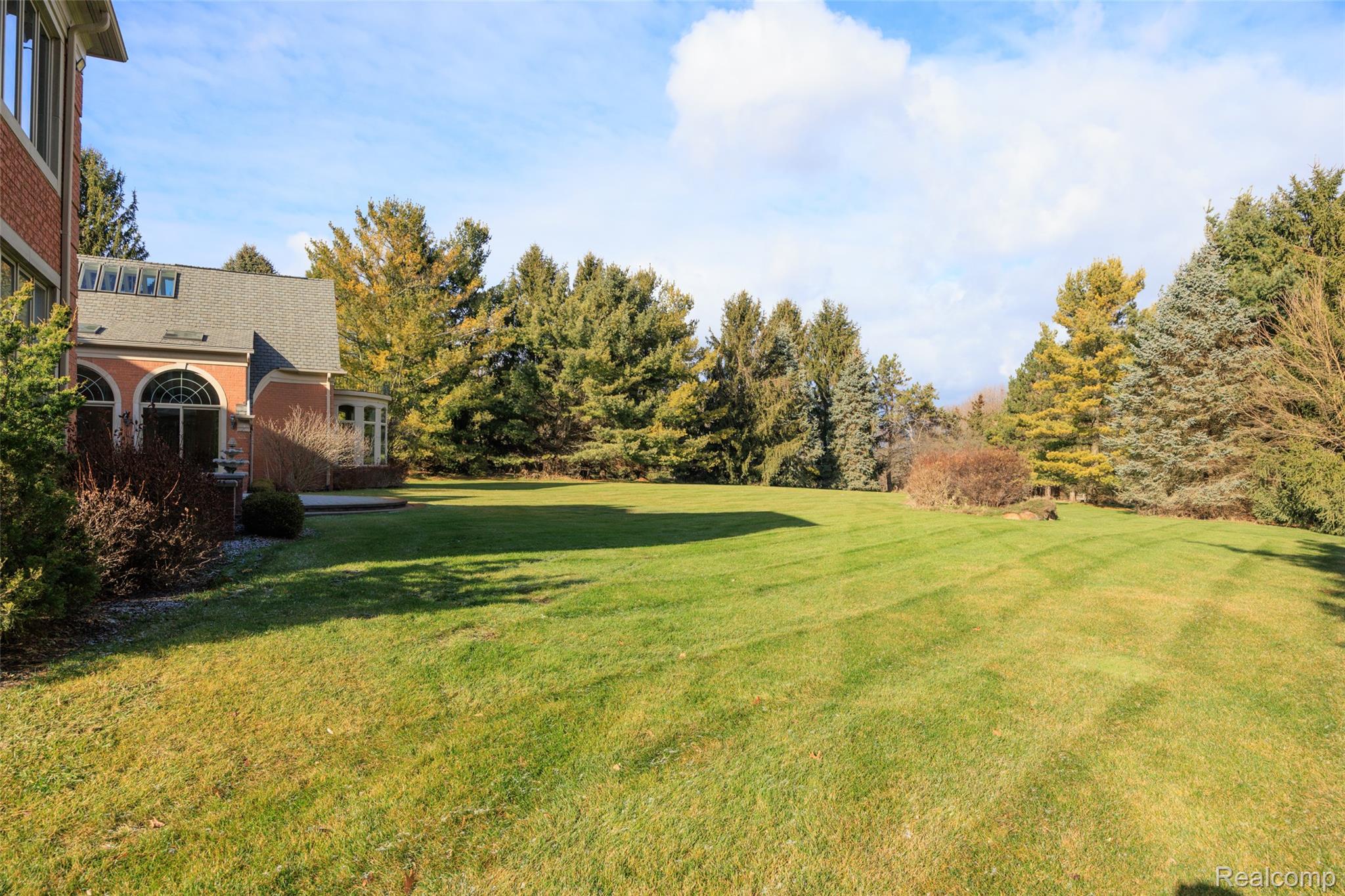 5165 Abbey Drive Rochester, MI 48306 - Photo 62 of 66 Expansive manicured lawn bordered by mature evergreen and deciduous trees
