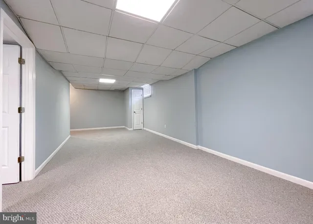 a front view of house with yard seating and barbeque oven