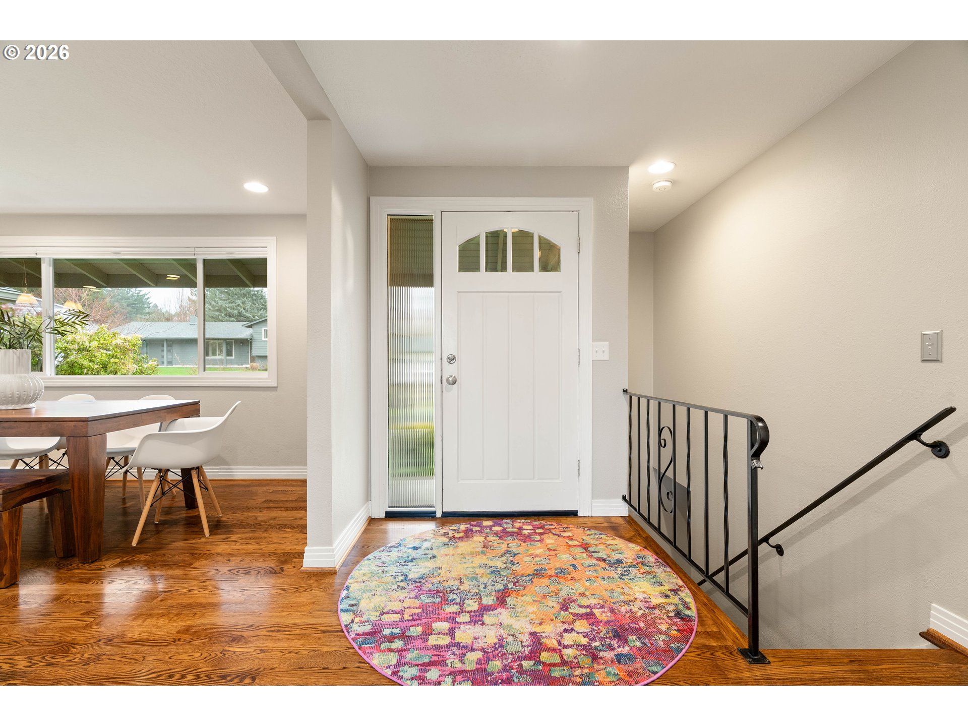 2125 Southwest Warwick Avenue Portland, OR 97225 - Photo 3 of 40 a view of a hallway with dining room and wooden floor