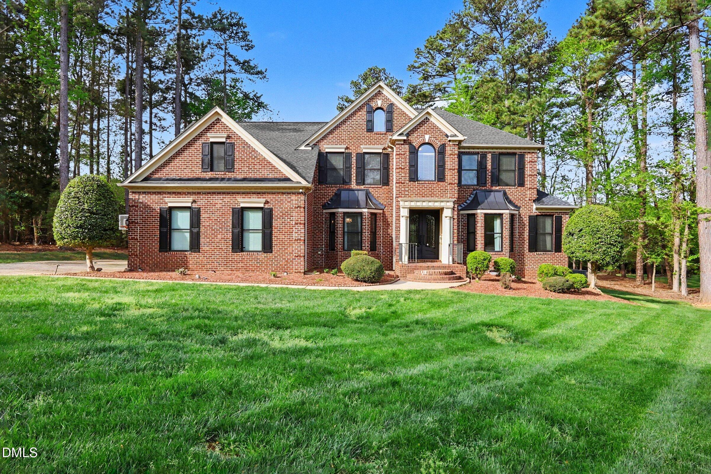 1001 Denfield Court Raleigh, NC 27615 - Photo 1 of 44 a front view of a house with yard and green space
