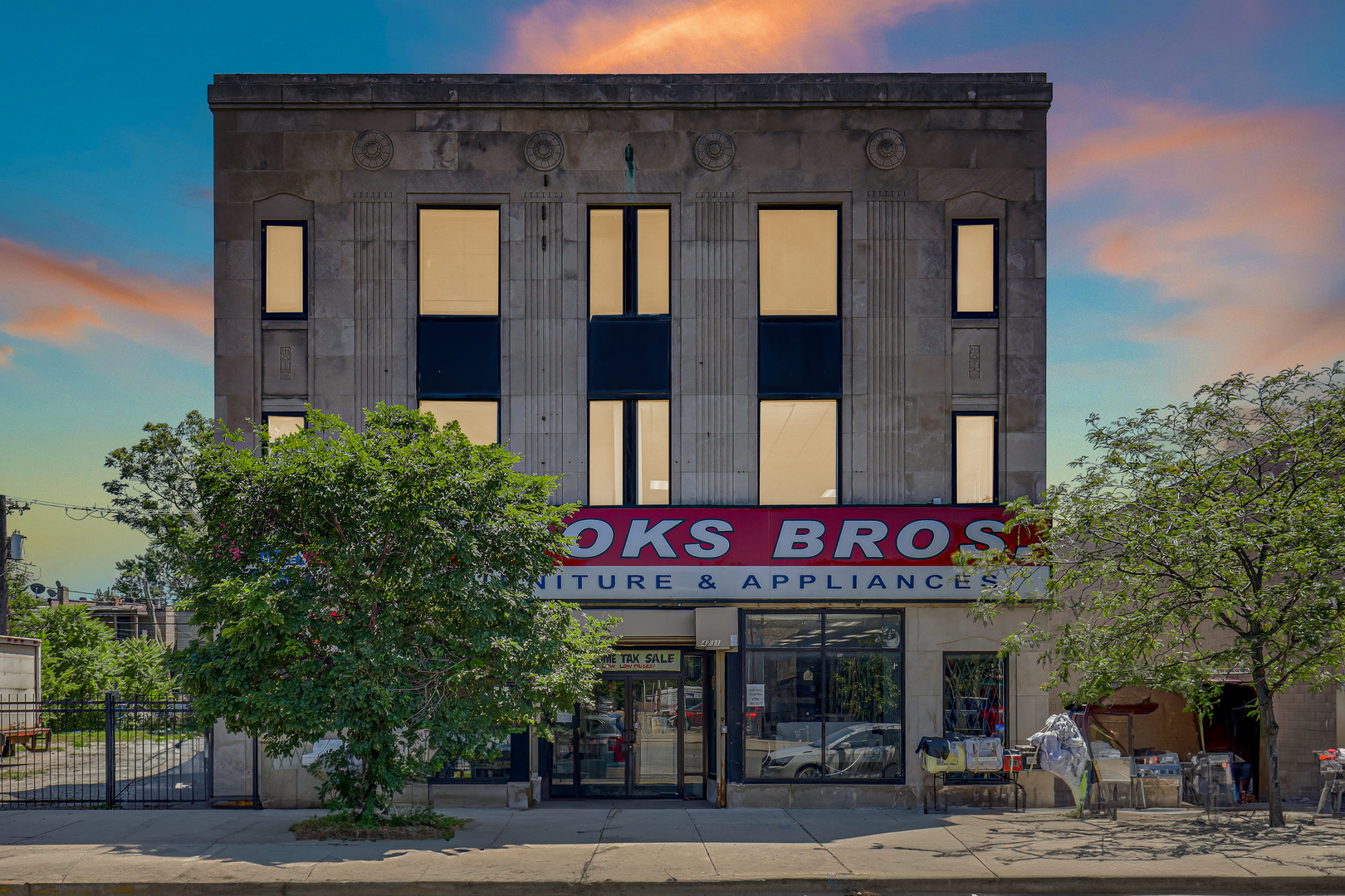 4231 West Madison Street Chicago, IL 60624 - Photo 2 of 19 a front view of multi story residential apartment building with yard and sign board