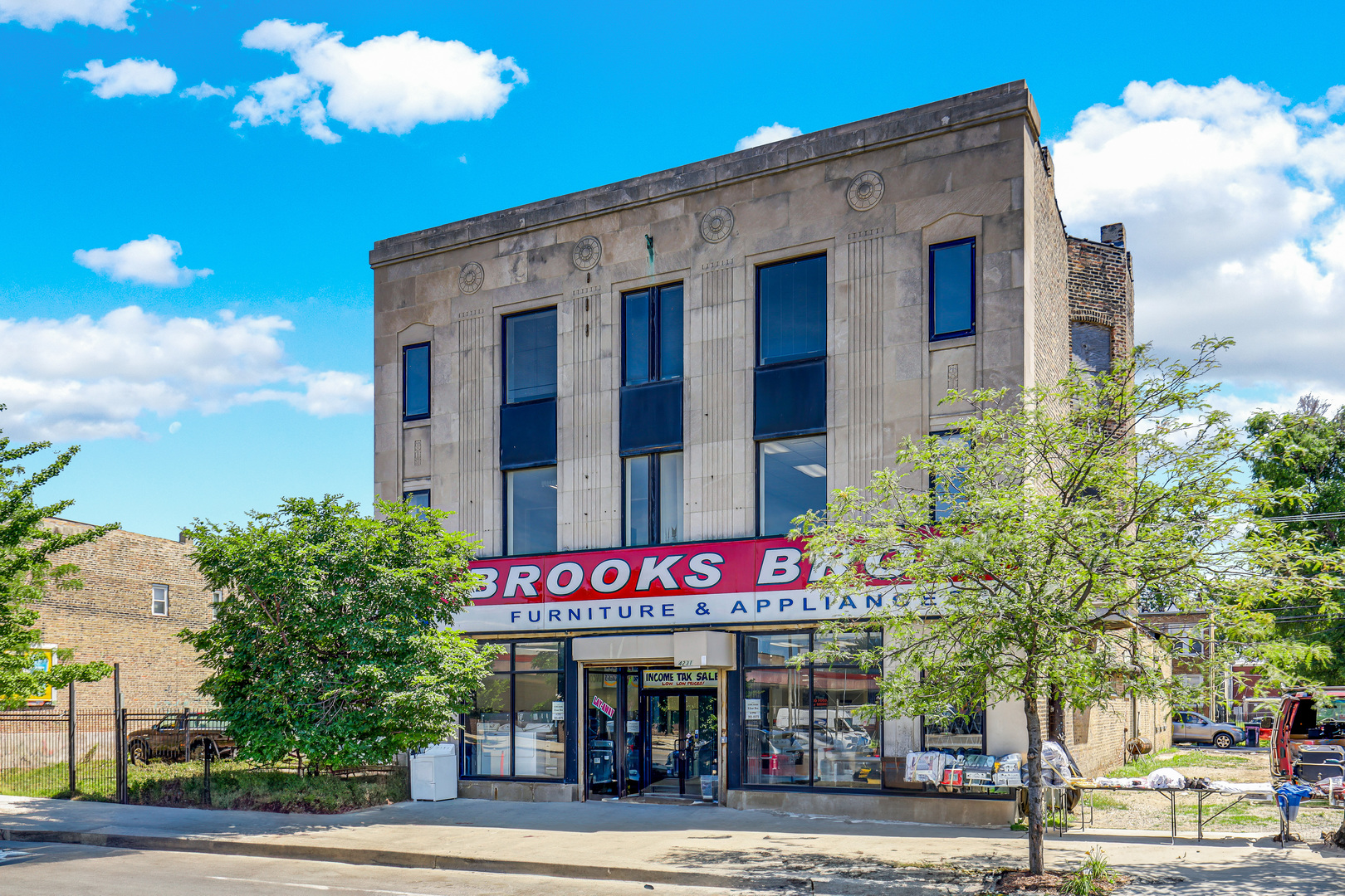 4231 West Madison Street Chicago, IL 60624 - Photo 3 of 19 a front view of multi story residential apartment building with yard