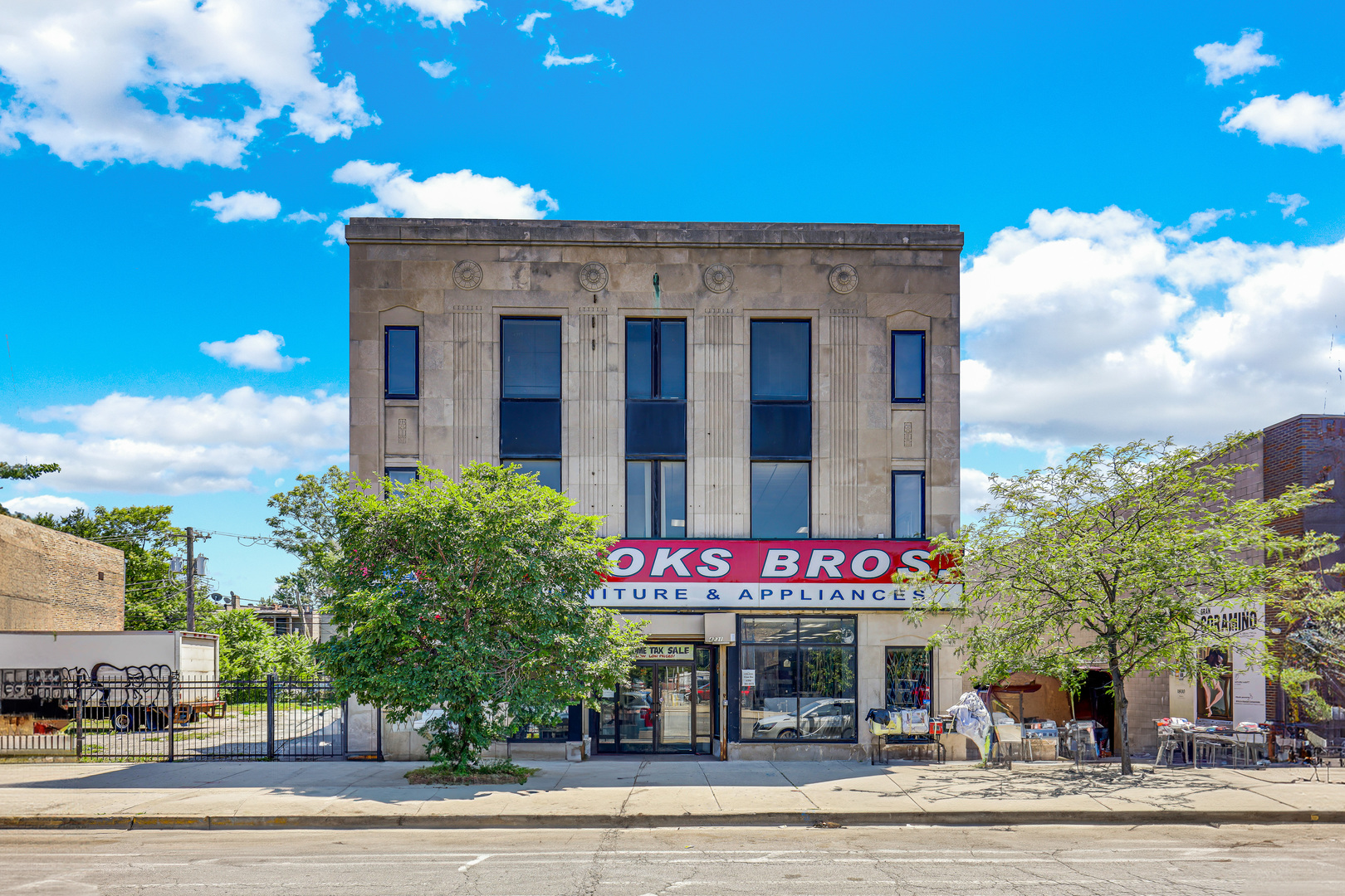 4231 West Madison Street Chicago, IL 60624 - Photo 5 of 19 a front view of multi story residential apartment building with yard