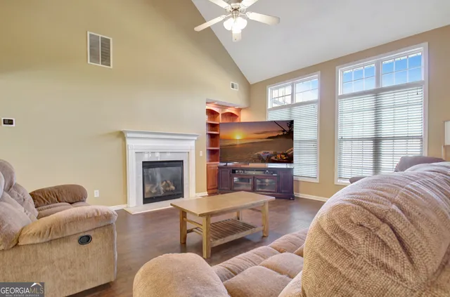 a living room with furniture and a fireplace