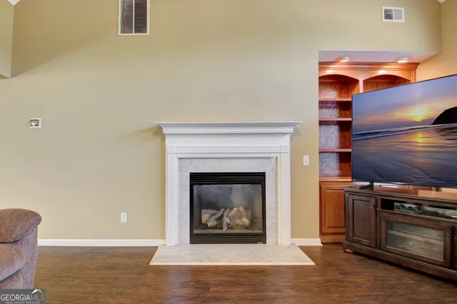 a living room with furniture a fireplace and a flat screen tv