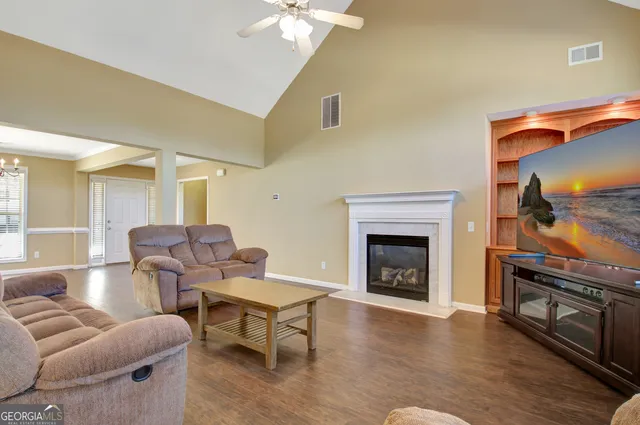a living room with furniture and wooden floor