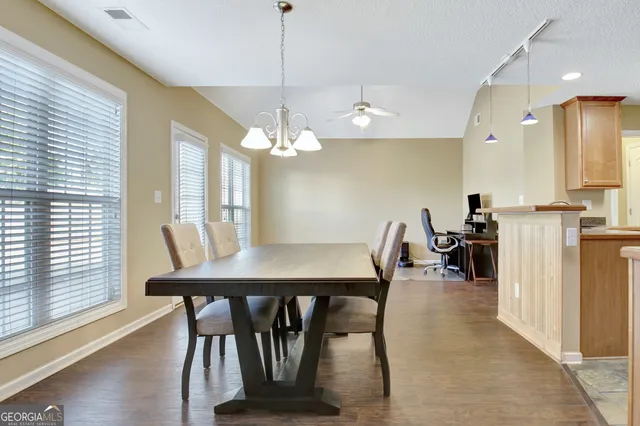 a view of a dining room with furniture window and wooden floor