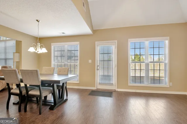 a view of a dining room with furniture and window
