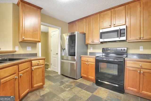 a kitchen with a sink cabinets and window