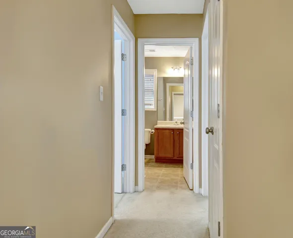 an empty room with a ceiling fan and window