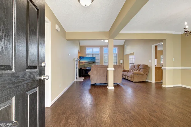 a living room with furniture and wooden floor