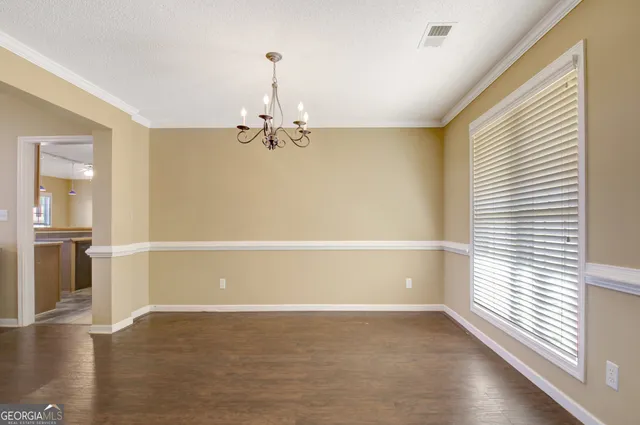 a view of a livingroom with wooden floor and a window