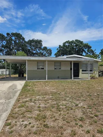 front view of a house with a yard and a trees