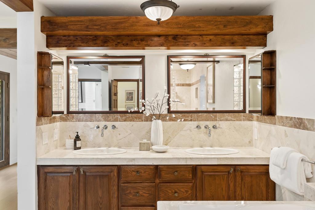 233 Cole Ranch Road Encinitas, CA 92024 - Photo 11 of 25 a bathroom with a granite countertop sink and a mirror