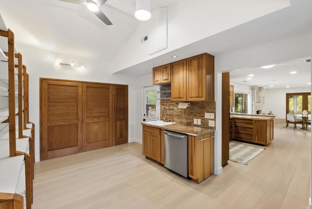 233 Cole Ranch Road Encinitas, CA 92024 - Photo 7 of 25 a kitchen with stainless steel appliances granite countertop a stove top oven a sink and a refrigerator