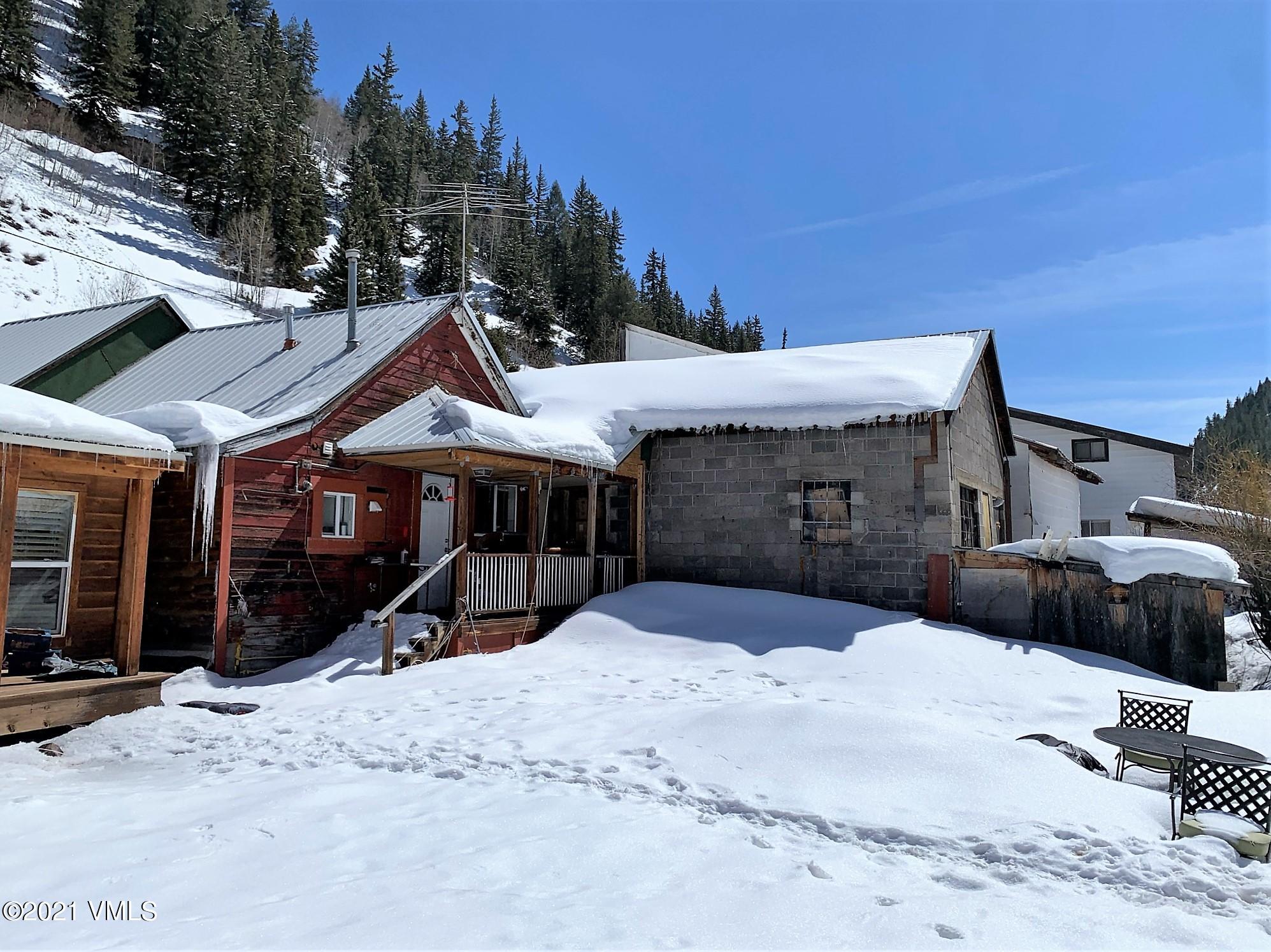 497 Eagle Street Red Cliff, CO 81649 - Photo 4 of 17 a view of a house with a yard covered in snow