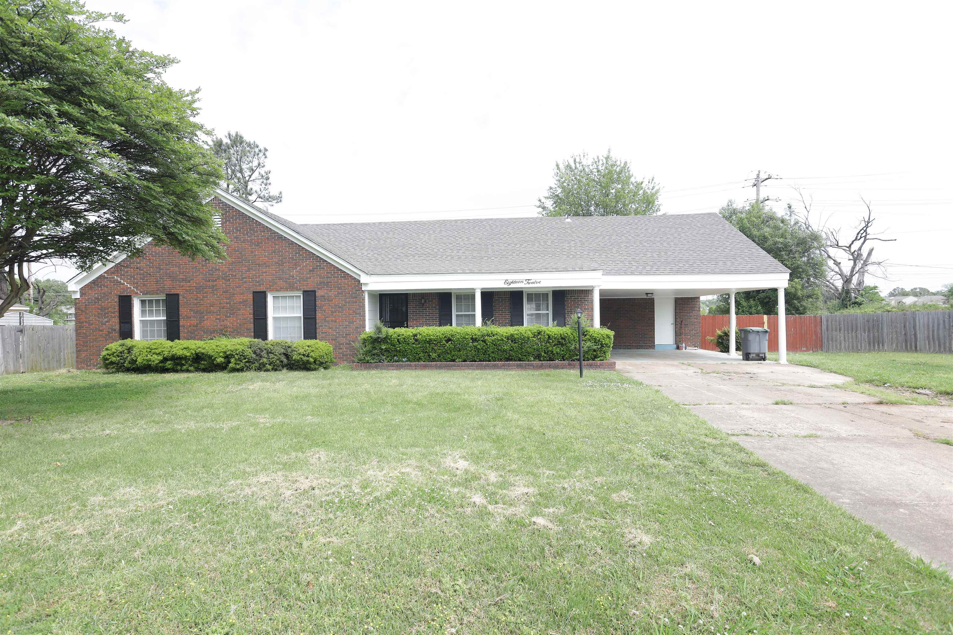 1812 Whitman Road Memphis, TN 38116 - Photo 1 of 18 a front view of a house with a garden