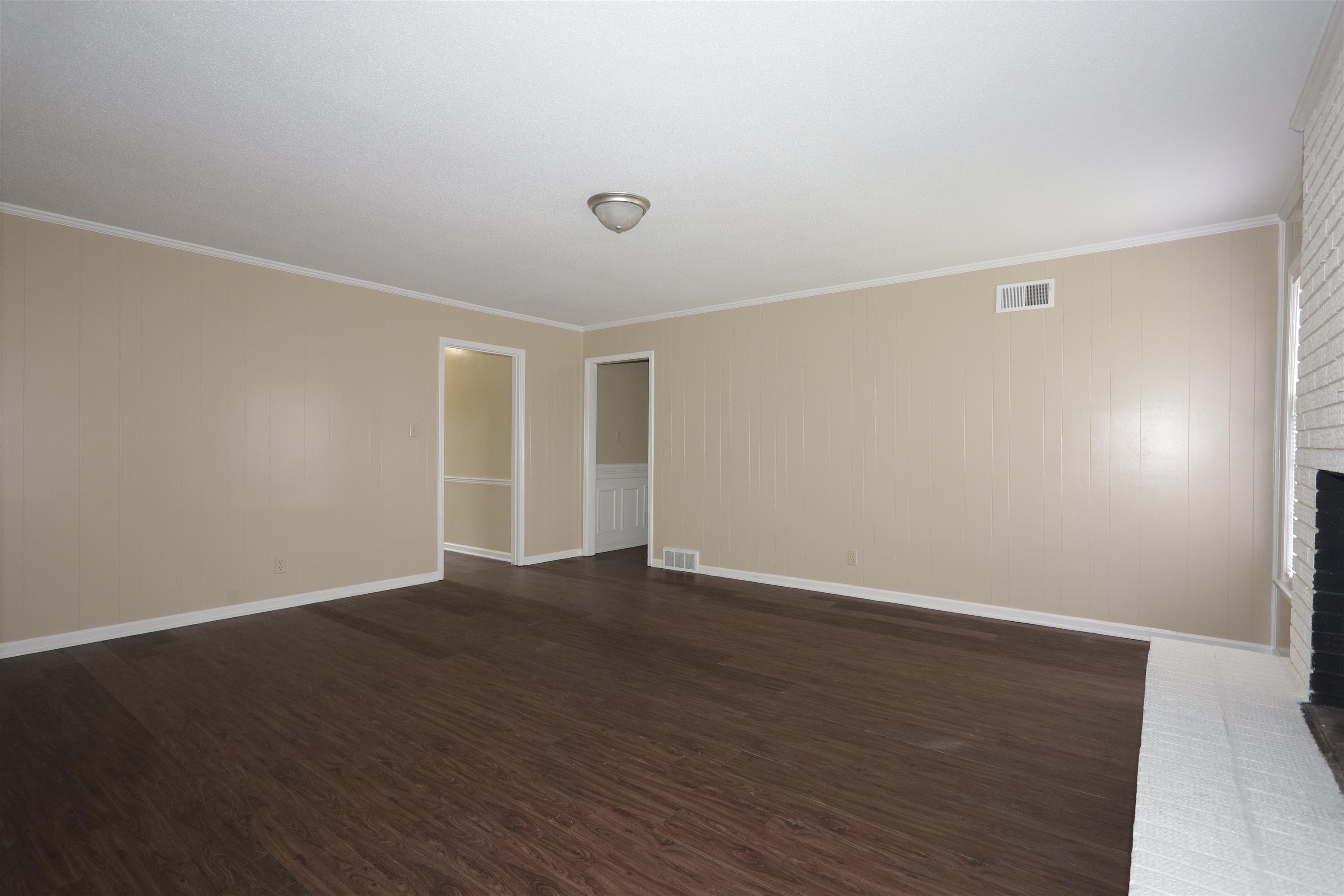 1812 Whitman Road Memphis, TN 38116 - Photo 11 of 18 a view of an empty room with wooden floor
