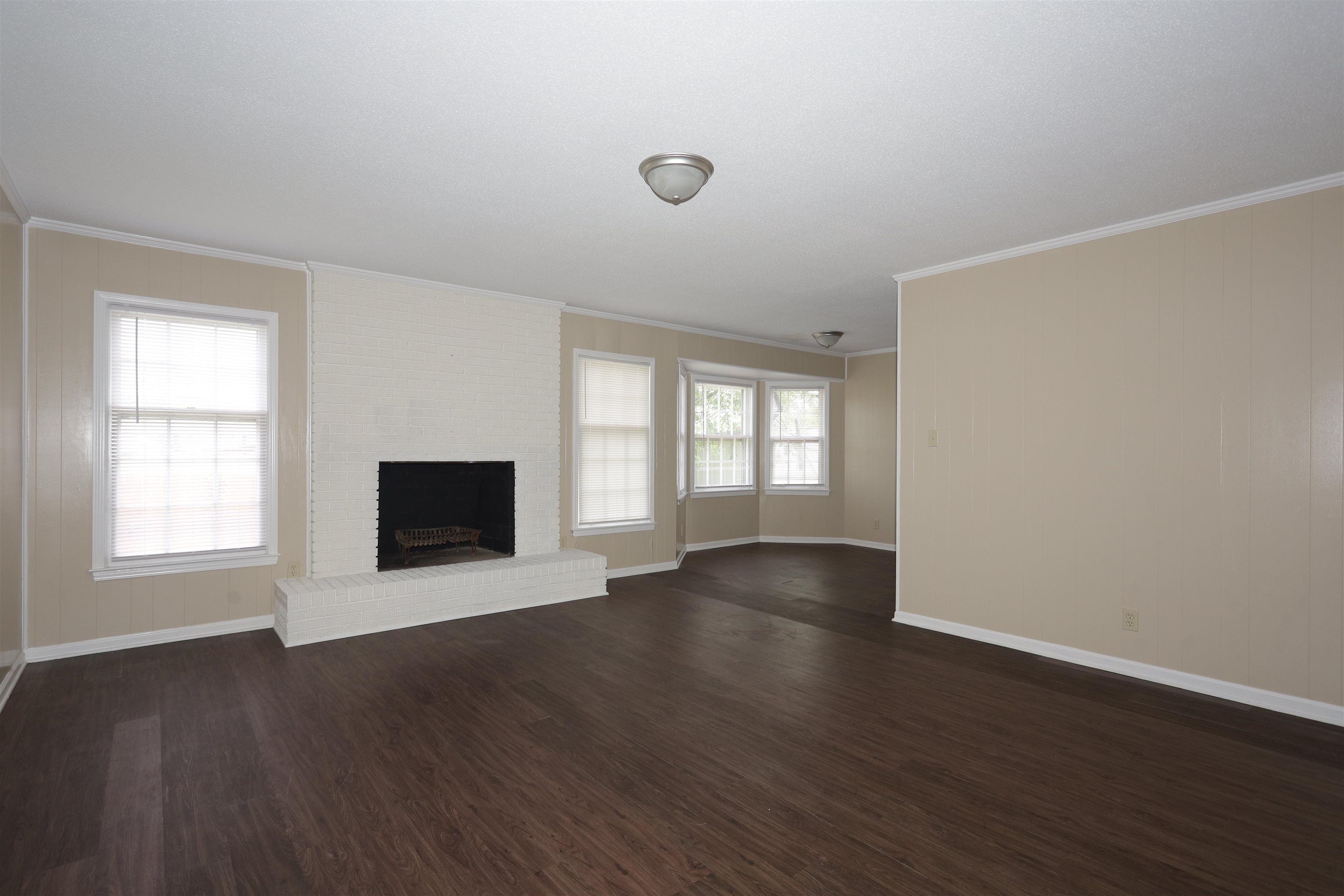 1812 Whitman Road Memphis, TN 38116 - Photo 12 of 18 an empty room with wooden floor and windows