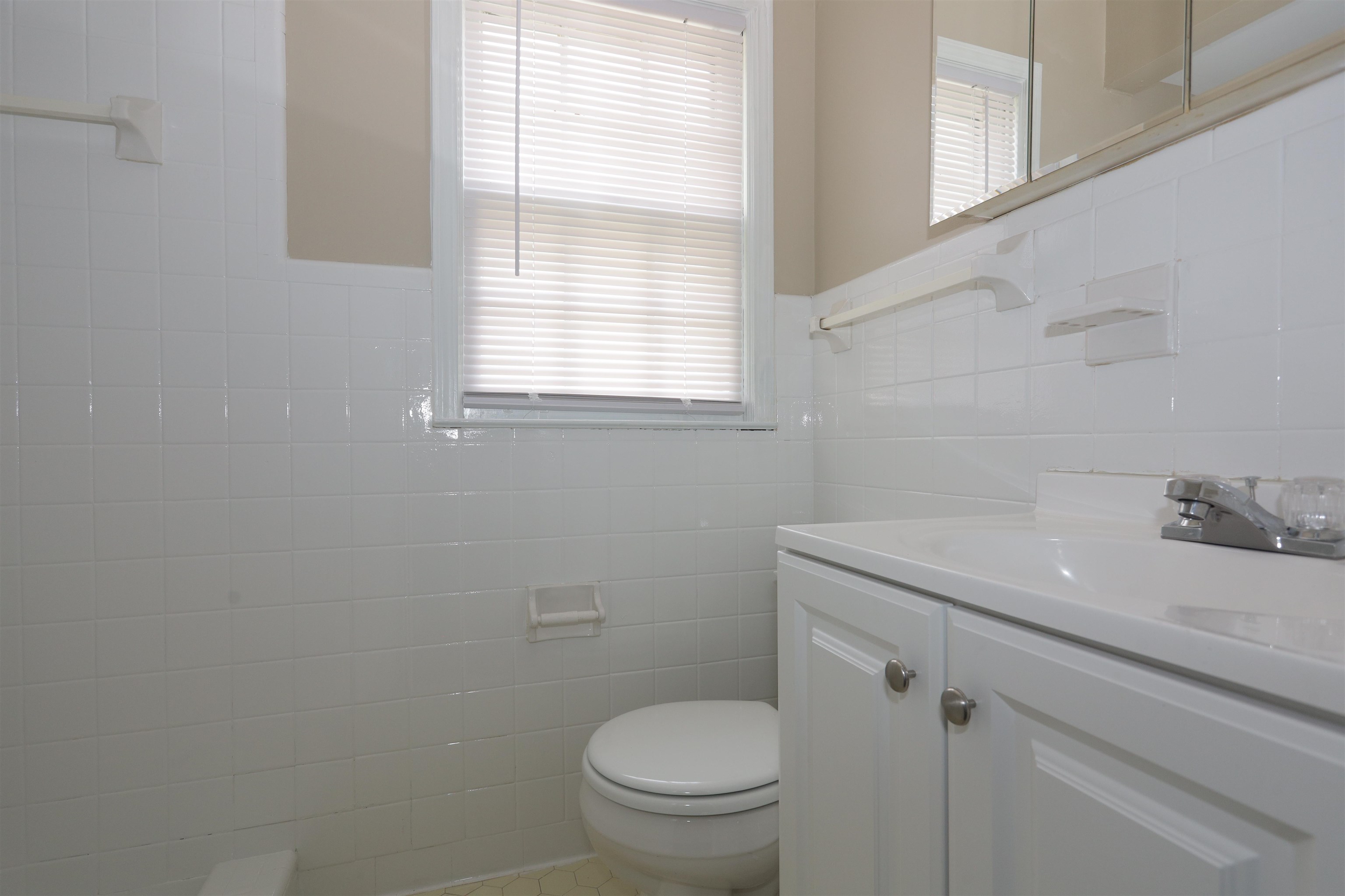 1812 Whitman Road Memphis, TN 38116 - Photo 15 of 18 a bathroom with a granite countertop toilet a sink and a window